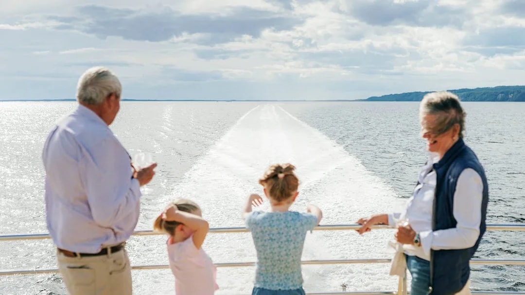 Old couple and kids enjoying the view on a World Heritage Cruise on Gordon River.