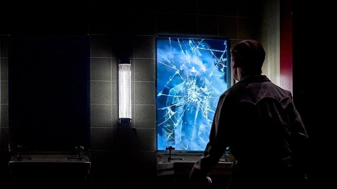 Man facing cracked mirror with reflection, Stranger Things: The First Shadow.