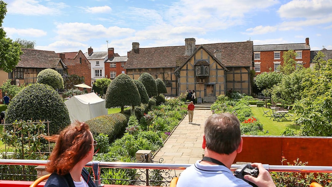 Visitors on a HOHO bus view Shakespeare's Birthplace in Stratford-upon-Avon.