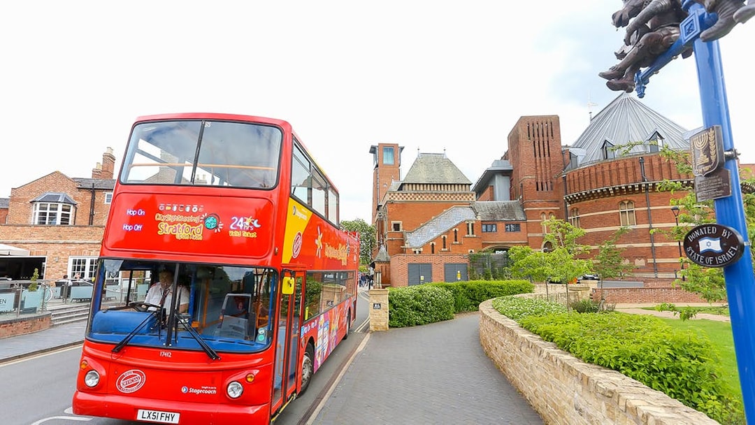 Red double-decker bus on City Sightseeing tour near Royal Shakespeare Theatre, Stratford-upon-Avon.