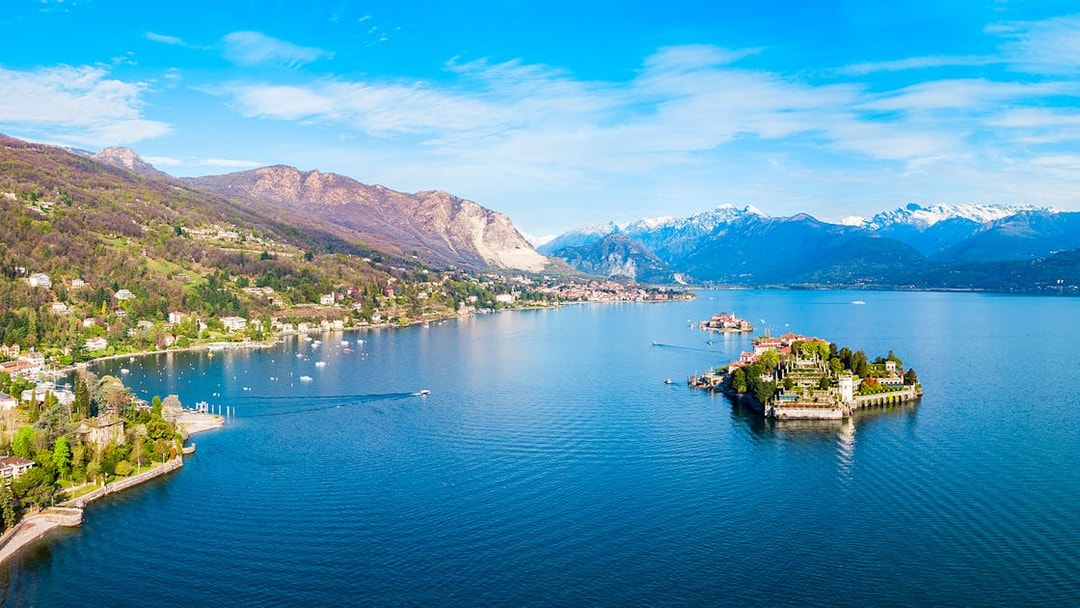 Aerial view of Isole Borromee on Lake Maggiore with mountains in the background.