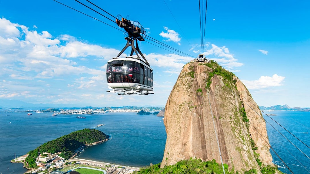 Cable car ascending Sugarloaf Mountain, Rio de Janeiro, with ocean view.