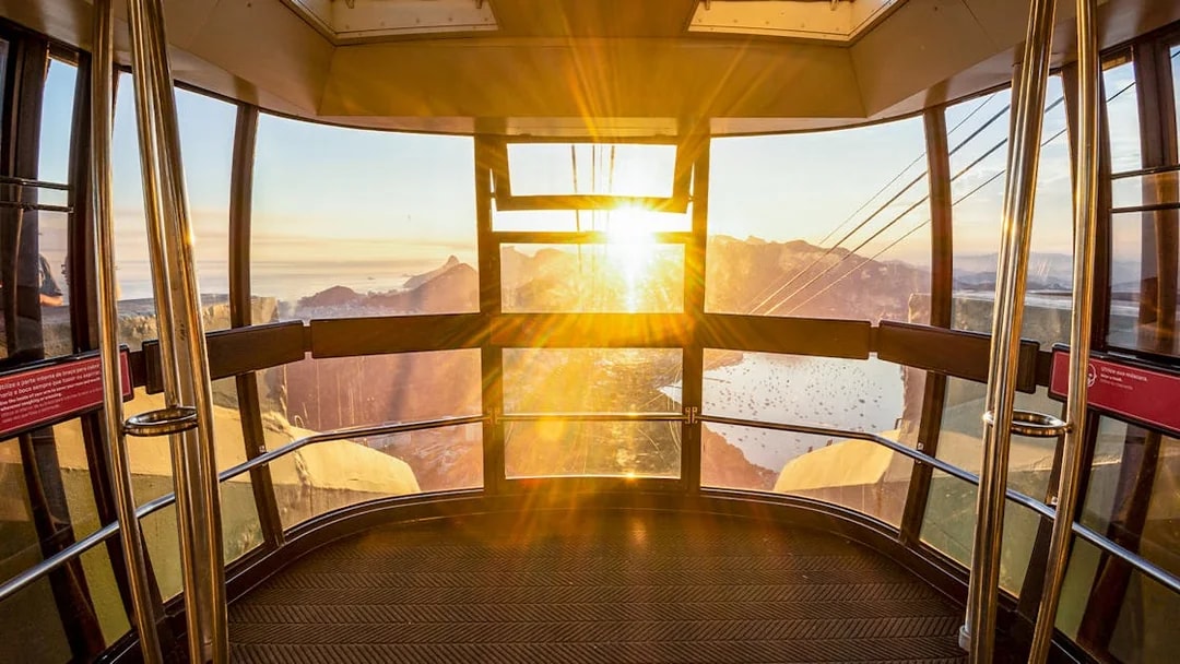 View of Rio de Janeiro from inside Sugar Loaf Mountain cable car at sunset.