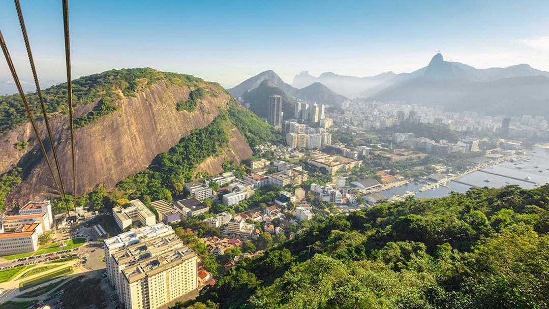Cable car ascending Pao de Acucar with view of Rio de Janeiro, Brazil.