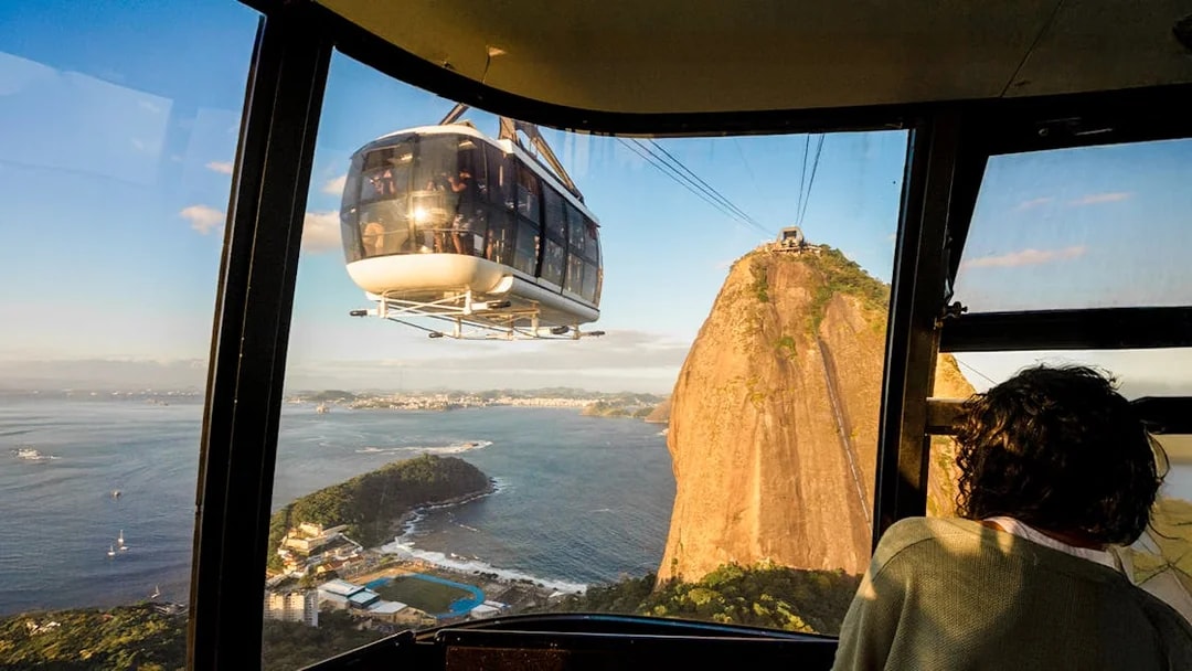 Cable car approaching Sugar Loaf Mountain at sunset, Rio de Janeiro.