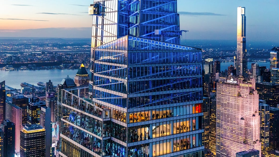 SUMMIT One Vanderbilt in New York City at dusk with city skyline.