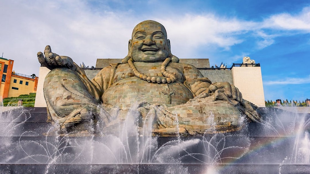 Giant Buddha statue with water fountains at Ba Den Mountain, Tay Ninh, Vietnam.