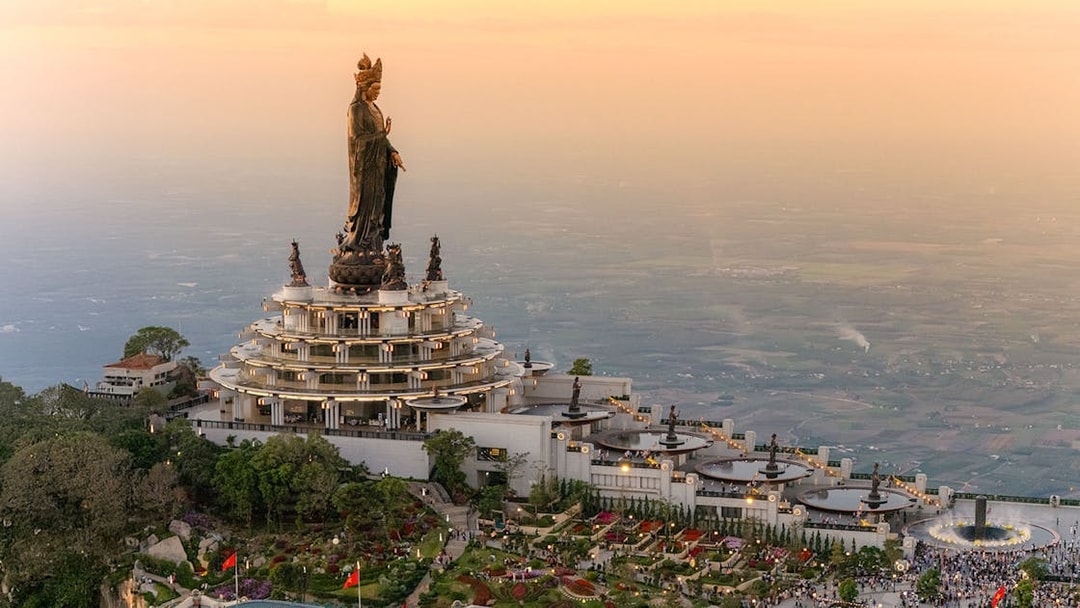 Ba Den Mountain temple complex with large statue at sunset, Tay Ninh, Vietnam.