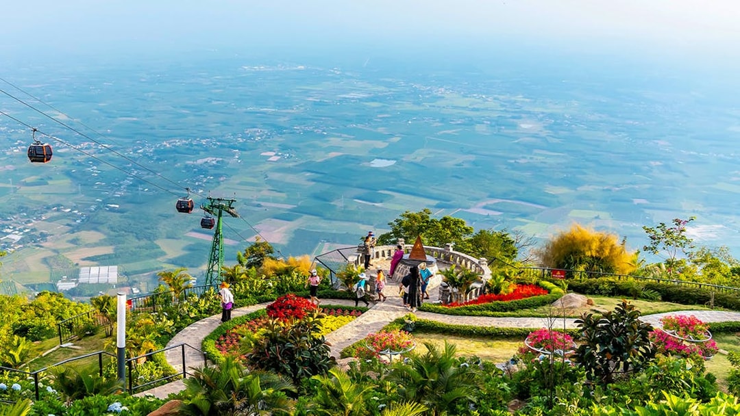 Cable cars over lush gardens at Sun World Ba Den Mountain, Vietnam.