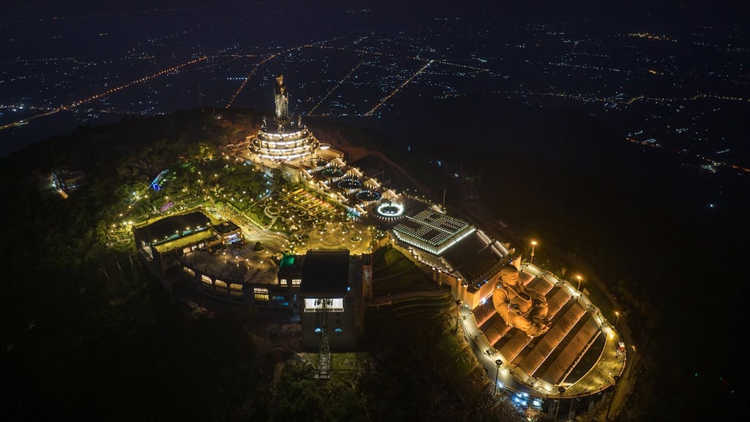 Aerial view of Sun World Ba Den Mountain at night, featuring illuminated Hang Pagoda and Van Son Peak.