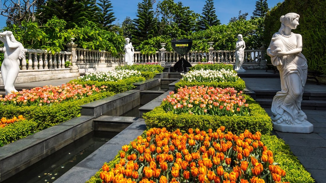 Ba Na Hills garden with colorful tulips and classical statues.