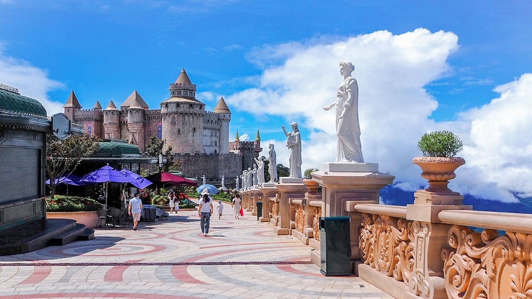 Luna Castle and statues in Ba Na Hills, Da Nang, Vietnam under a clear sky.