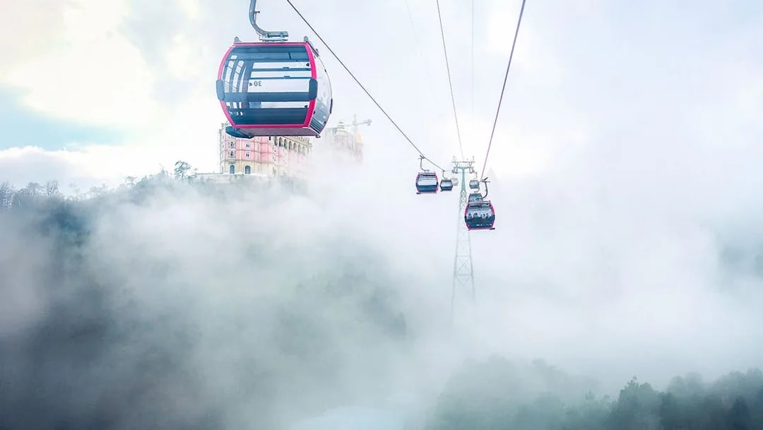 Cable car ascending through mist to Ba Na Hills Mountain Resort, Vietnam.