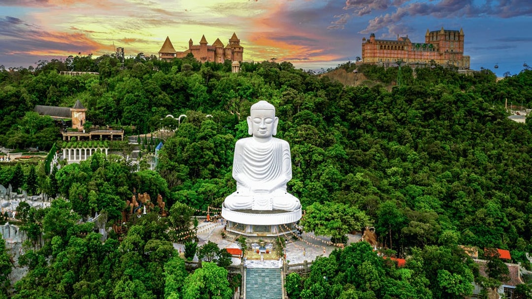Aerial view of Buddha statue surrounded by lush greenery at Bana Hills, Da Nang, Vietnam.