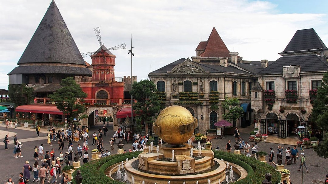 Central square in Ba Na Hills with globe fountain and European-style buildings.