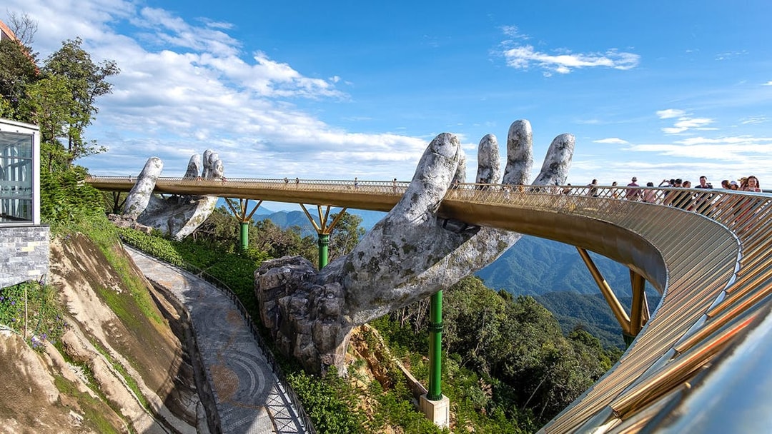 Golden Bridge held by giant hands at Sun World Ba Na Hills, Vietnam.