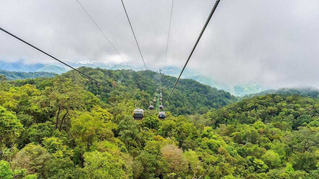 Cable car over lush forest at Sun World Ba Na Hills, Vietnam.