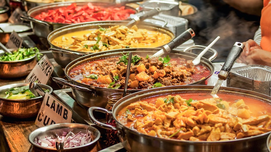 Indian buffet with various curries and dishes at KL Tower restaurant.