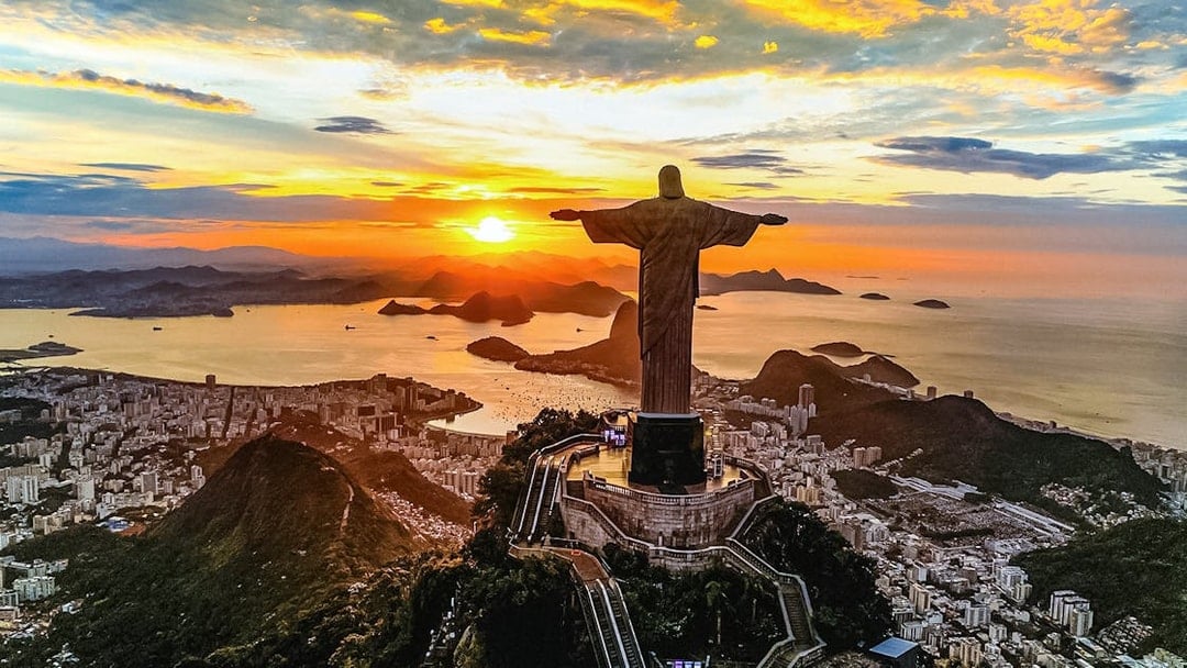 Aerial view of sunset over Christ the Redeemer statue in Rio de Janeiro, Brazil.