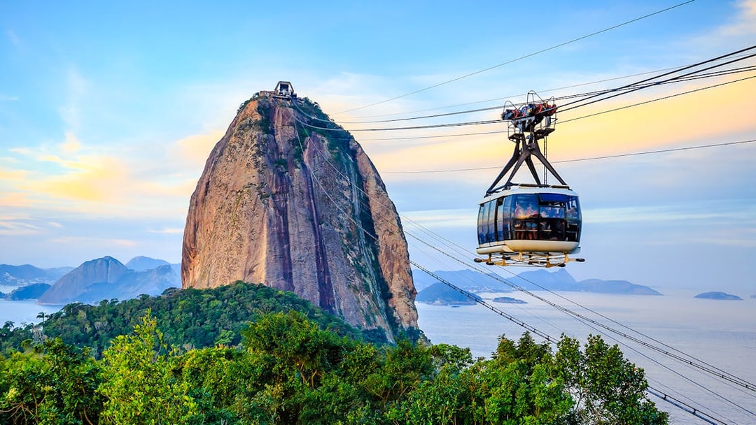 Cable car ascending Sugar Loaf Mountain, Rio de Janeiro, with ocean view.