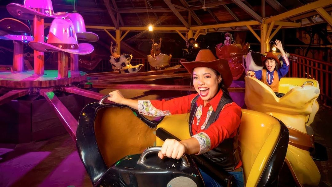 Visitors enjoying a cowboy-themed ride at Sunway Lagoon Night Park.