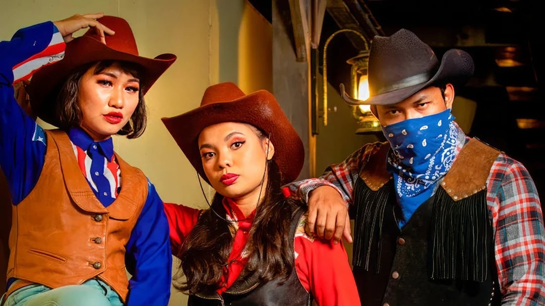 Cowboys and cowgirls in western attire at Sunway Lagoon Night Park.