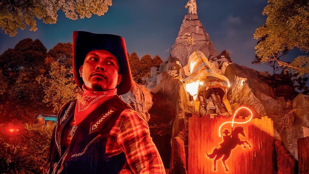 Park employee in cowboy attire at The Good The Bad and The Wild attraction.