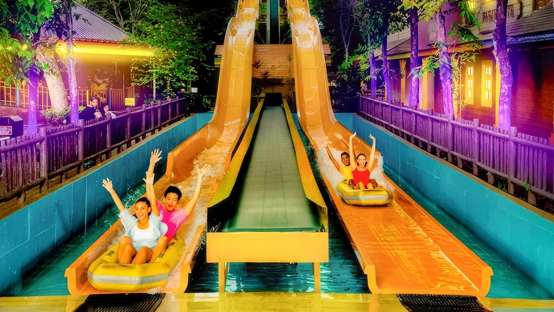 People enjoying water slides at Sunway Lagoon Night Park, Kuala Lumpur.