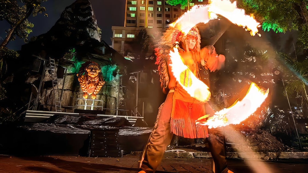 Fire performer with flaming hoops at Sunway Lagoon Night Park, Malaysia.