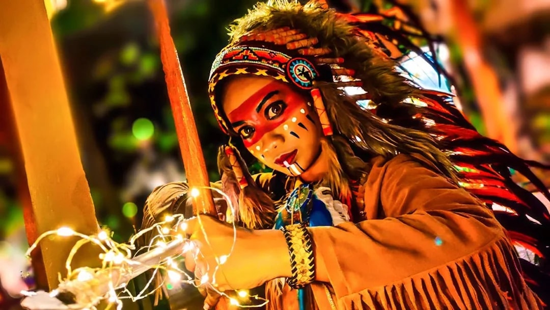 Performer in traditional costume with face paint at Sunway Lagoon Night Park.