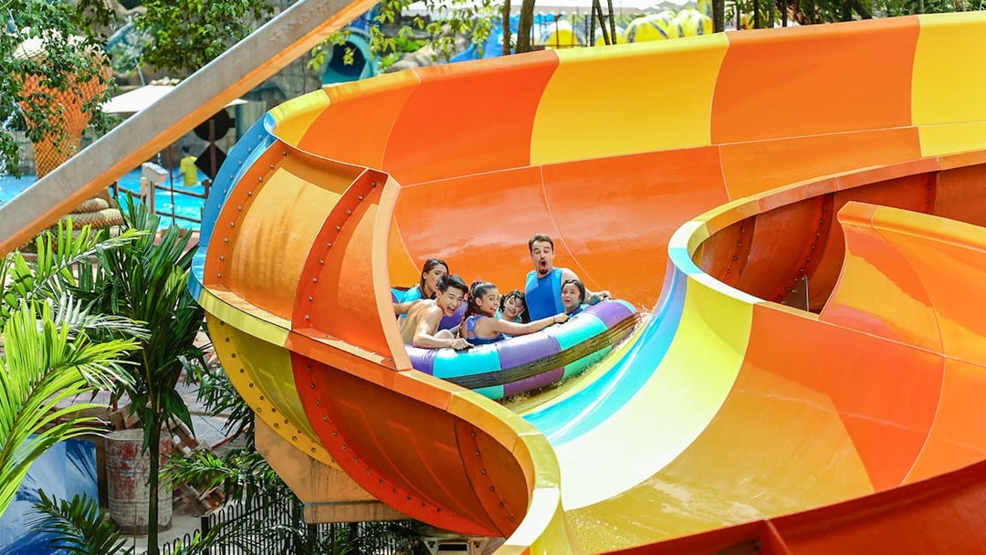 Group enjoying a colorful water ride at Sunway Lagoon theme park.
