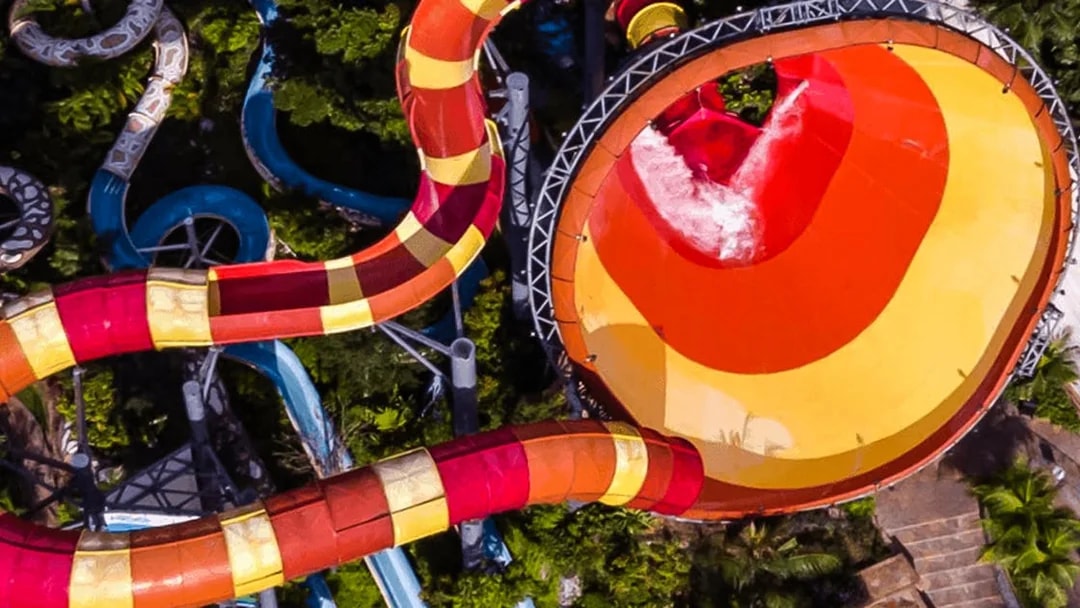 Water slide at Sunway Lagoon, Malaysia, surrounded by lush greenery.