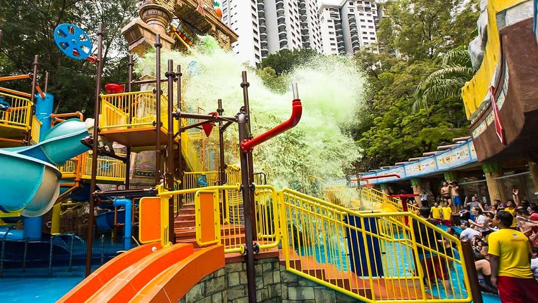 Sunway Lagoon water park splash area with slides and visitors in Kuala Lumpur.