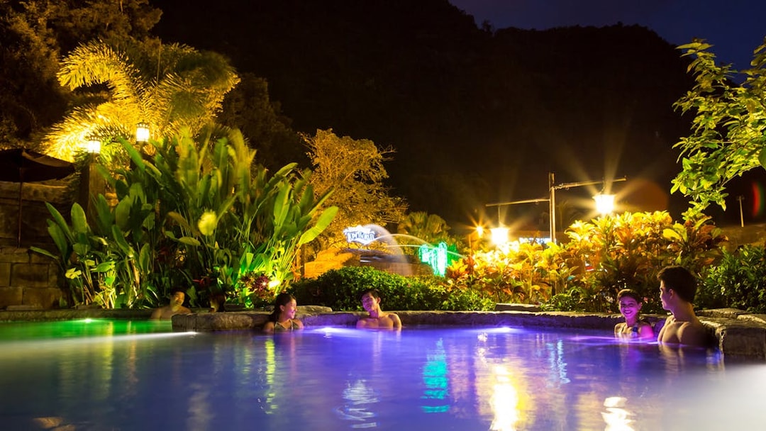 Infinity pool at night with people relaxing, Sunway Lost World of Tambun, Malaysia.