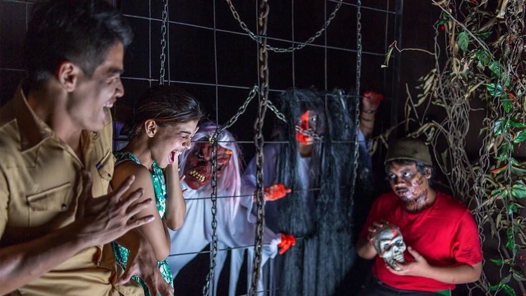 Visitors experiencing a haunted attraction at Sunway Lost World of Tambun, Malaysia.