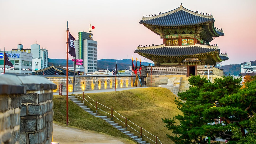 Suwon Hwaseong Fortress wall and watchtower at sunset, South Korea.