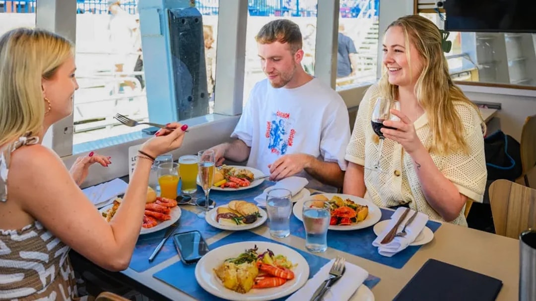 People enjoying lunch on a Swan River cruise in Perth.