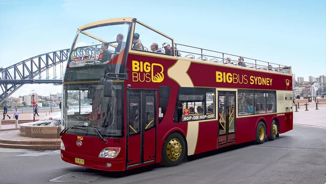Big Bus Sydney tour with Sydney Harbour Bridge in the background.