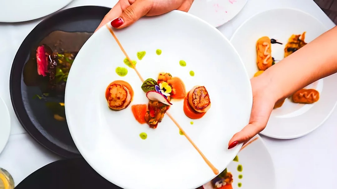 Scallops and garnishes served on a plate during the Gold Penfolds Dinner & Drinks Cruise, Sydney Harbour.
