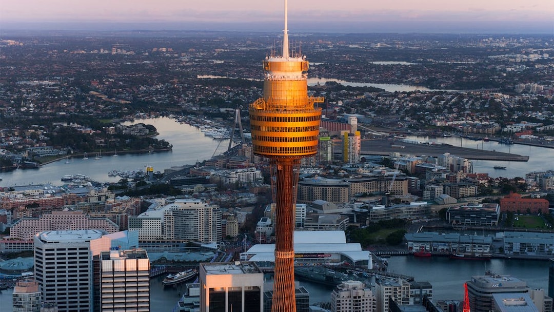 Sydney Tower Eye overlooking the cityscape and harbor at sunset.