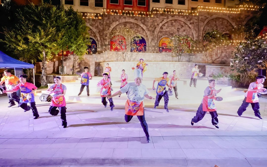 Performers in colorful costumes dancing at Sun World Hon Thom.