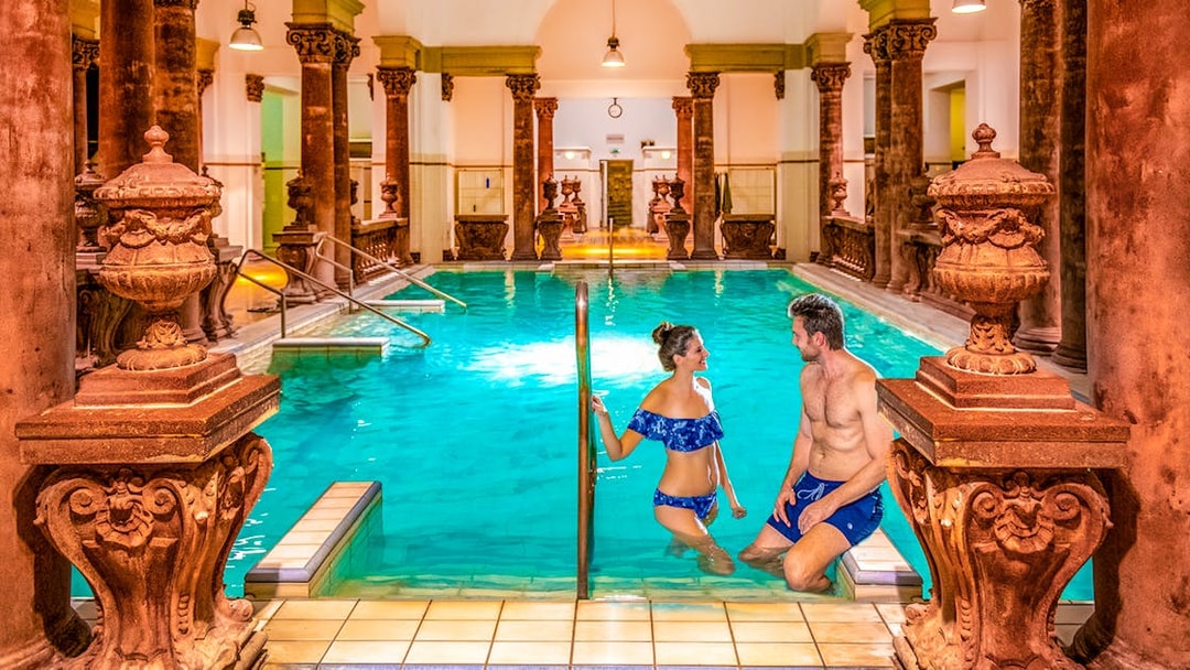 Indoor pool with ornate columns at Széchenyi Spa, Budapest.