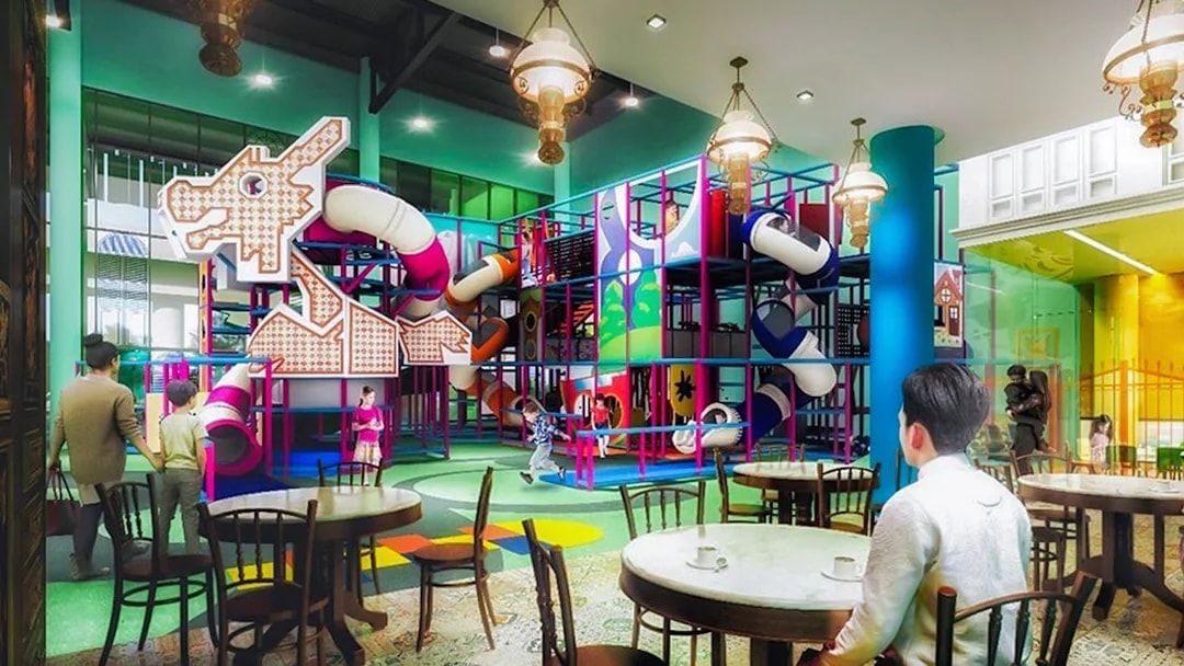 Indoor playground with colorful slides and climbing structures at T-Play Khatib.