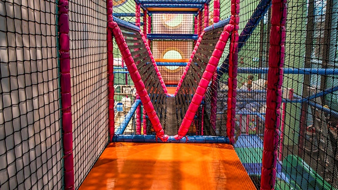 Indoor play area with netted bridge at T-Play Khatib.
