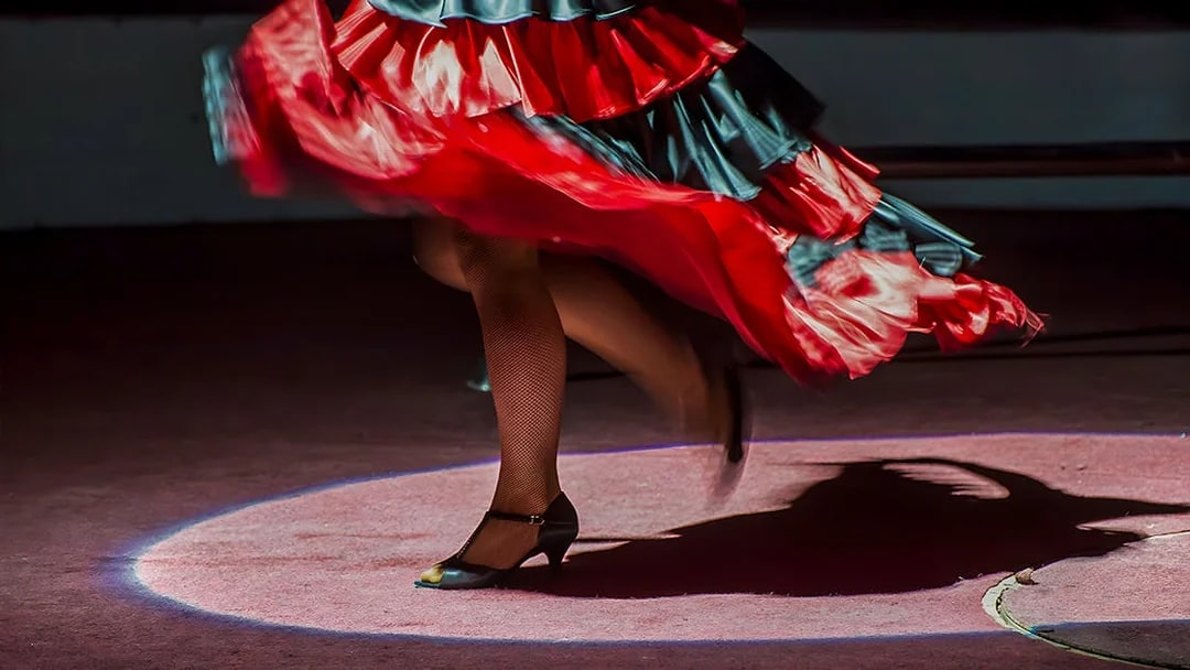 Flamenco dancer's feet in motion at Tablao El Arenal, Seville.