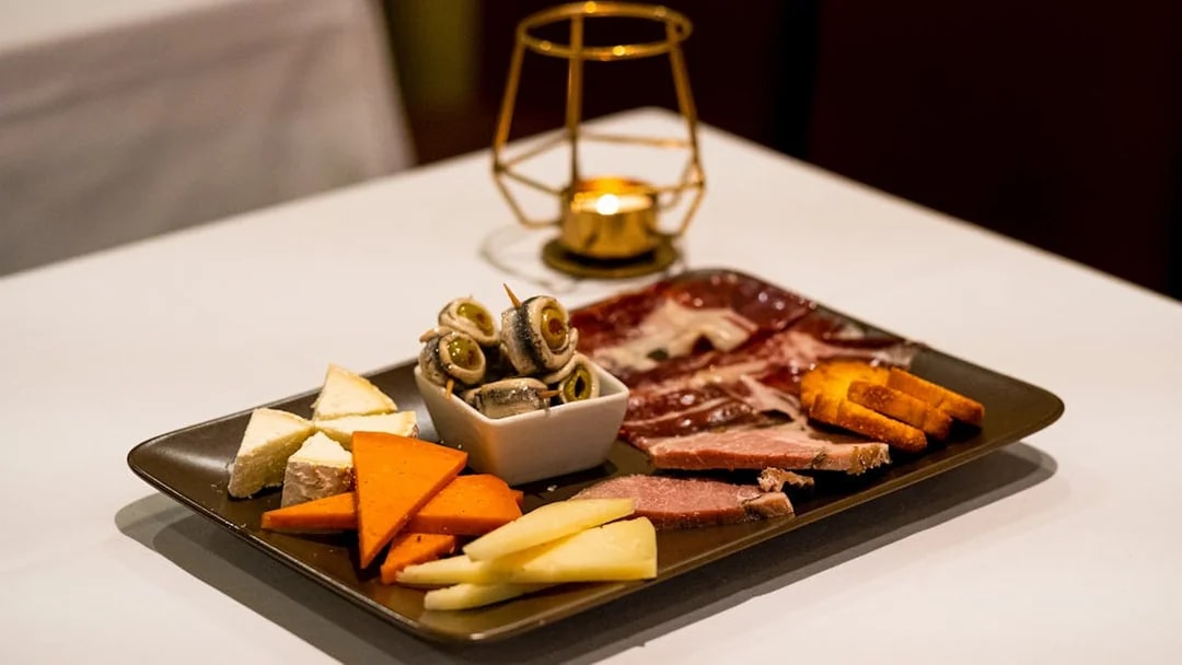 Spanish tapas platter with cheese, meats, and olives served at a Pure Flamenco Show.