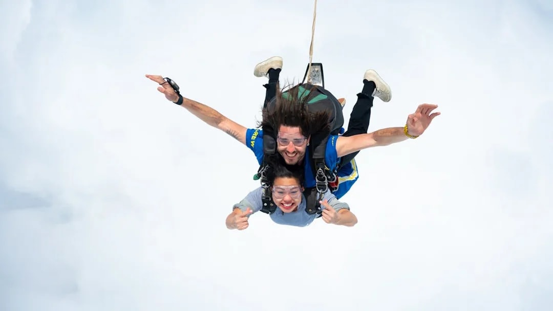 Tandem skydive over Great Ocean Road with instructor and participant freefalling.