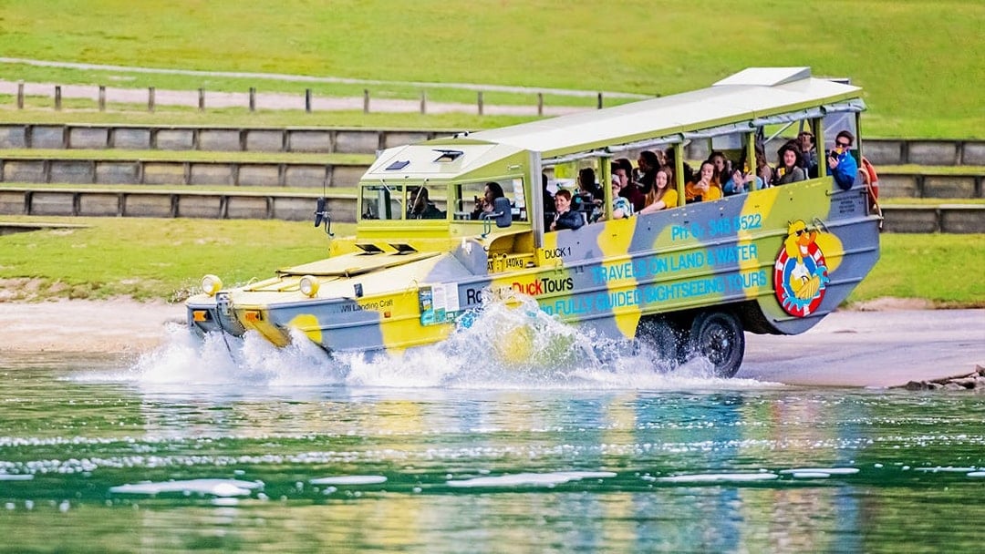 Amphibious tour vehicle entering water during Rotorua City & Lakes Tour.