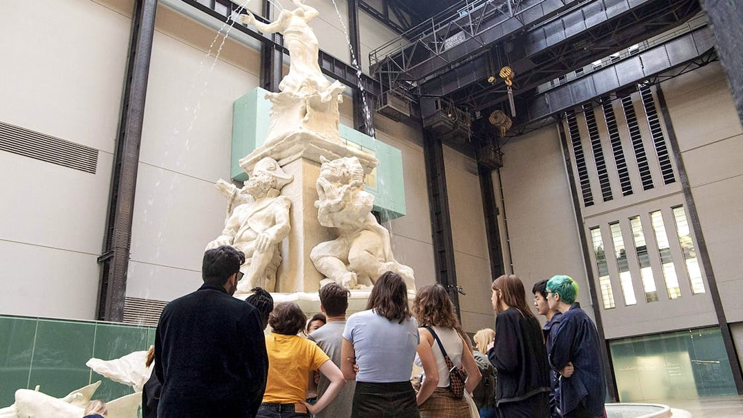 Visitors observing a large sculpture inside Tate Modern during the Discovery Tour.