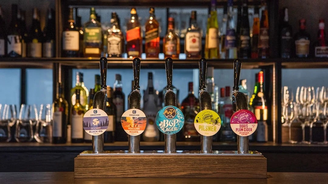 Bar with various beer taps at Te Puia's Hāngī Buffet Dinner in Rotorua, New Zealand.